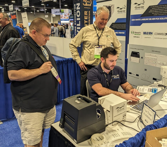 Head of Sales showing how a Fox-in-a-Box thermal printer works at the Bicsi Winter Conference