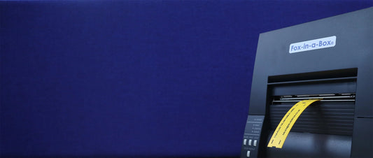 Fox-in-a-Box thermal Label Printer with yellow Fox-Flo cable labels / wire markers coming out of the front